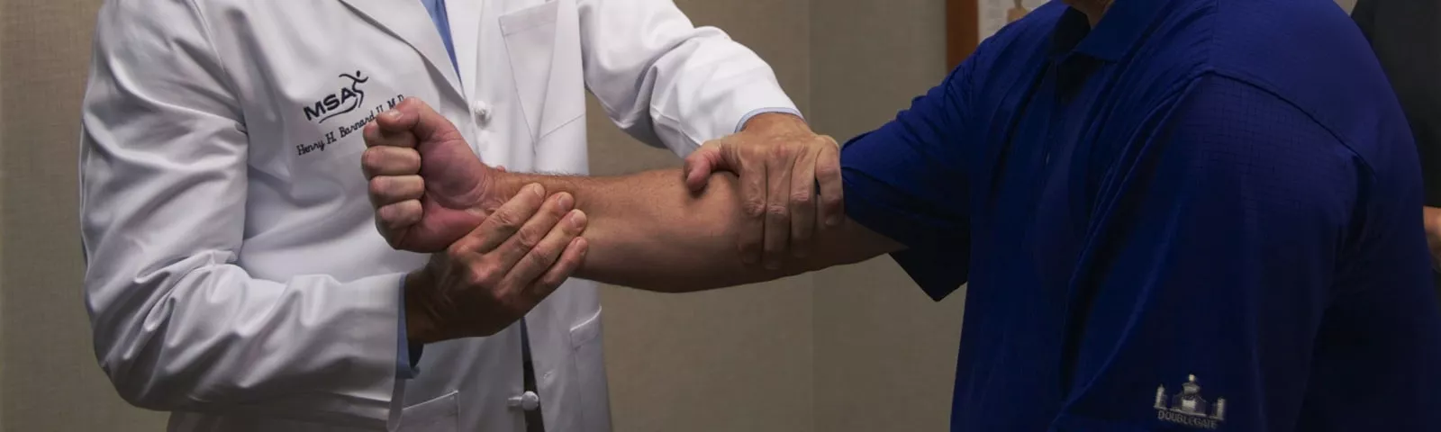 Dr. Barnard examines a patient's arm