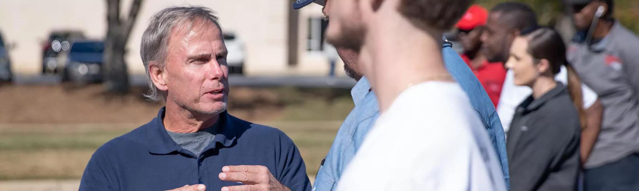 Physical Therapist speaking to a client on a field